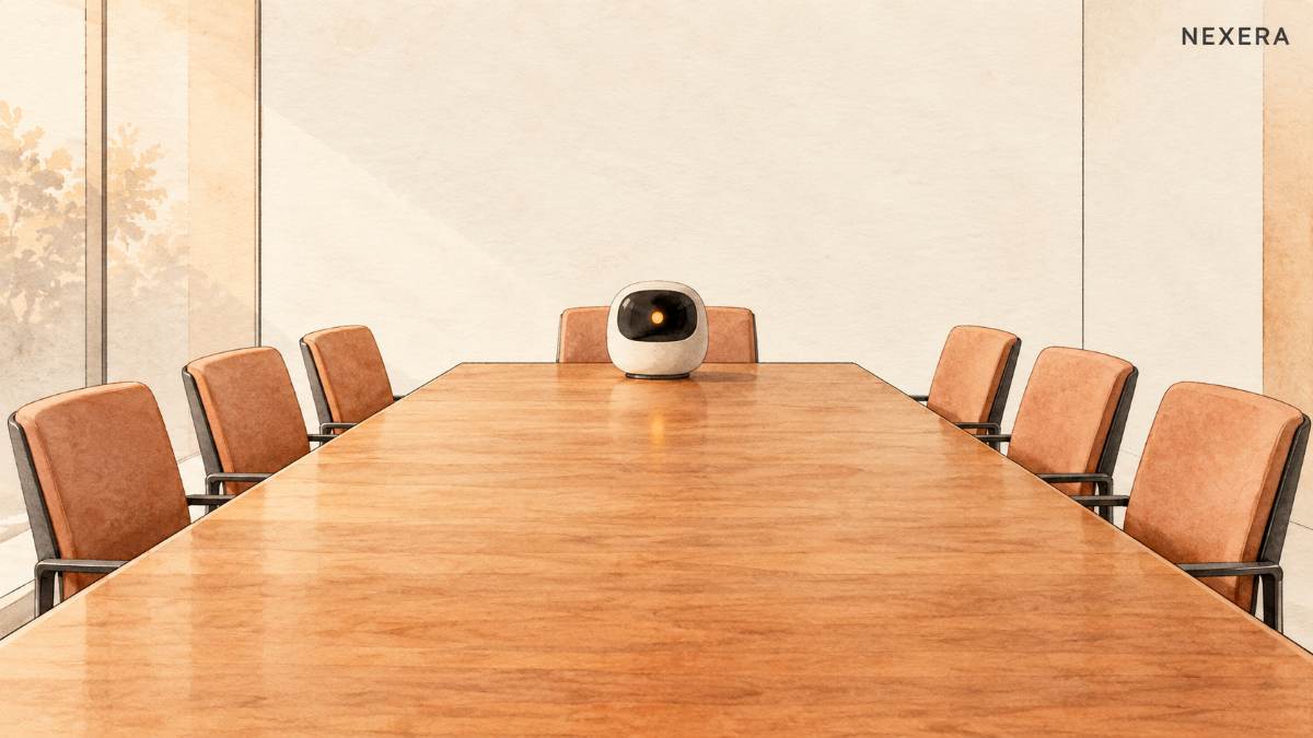 A small rounded recording robot with a glowing amber dot sitting alone at the head of a long empty conference table