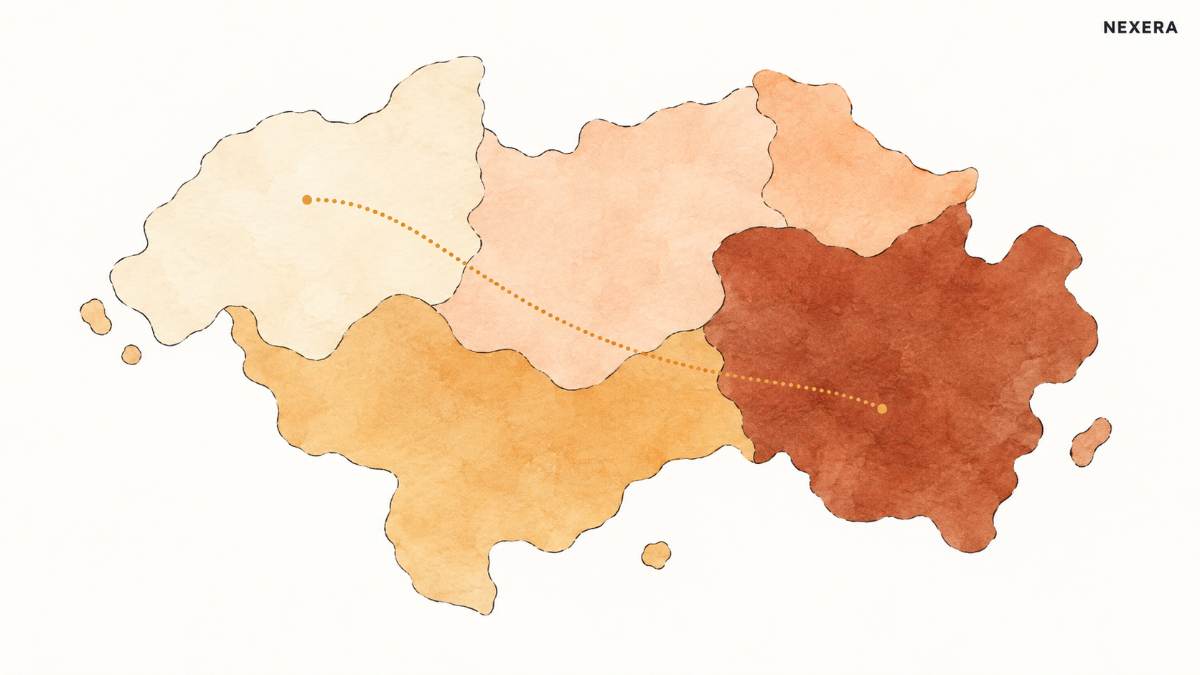 An overhead view of a warm-toned patchwork map with regions shaded in different amber and terracotta tones, a dotted line crossing from one region into a darker one